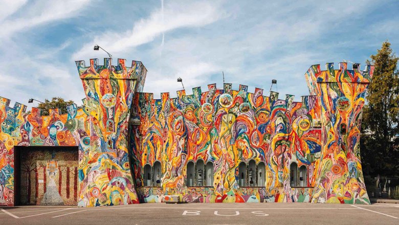 Bunt bemalte Fassade eines Geb&auml;udes in Form einer Burg mit T&uuml;rmen.